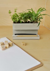 hoeked betonnen pennenbak met plantjes